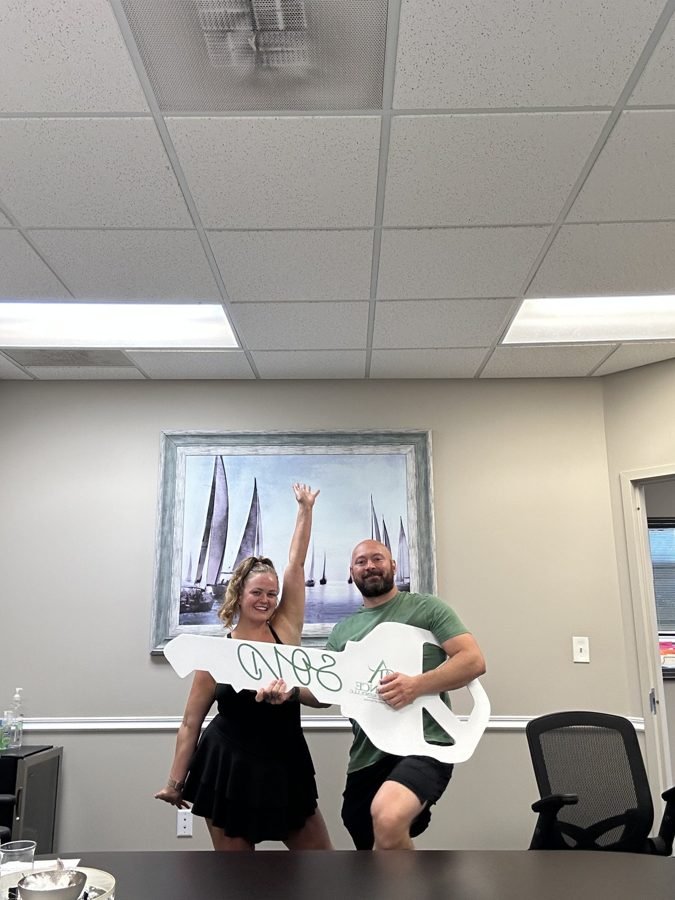 Group of sellers holding a giant SOLD key
