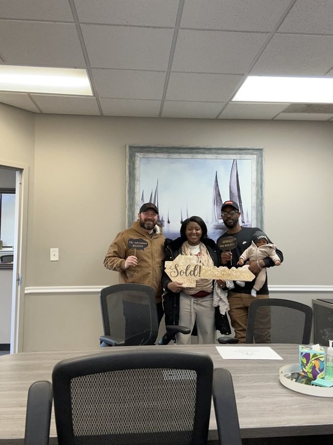 Sellers holding their proceeds check at closing