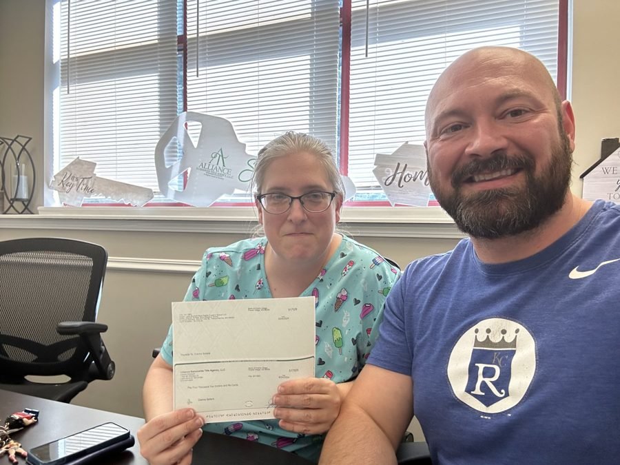 Sellers celebrating with checks and keys